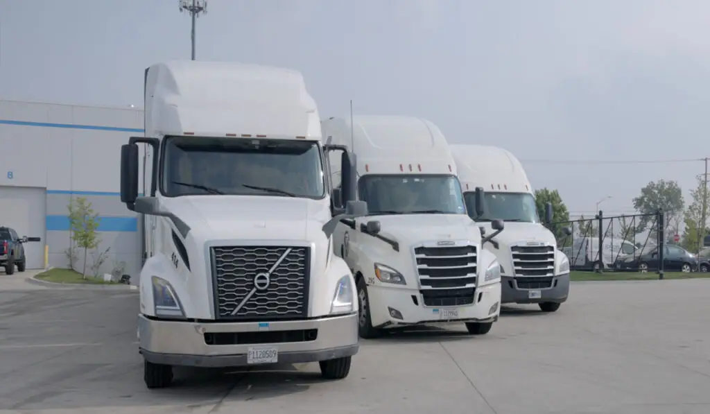 three white cargo trucks