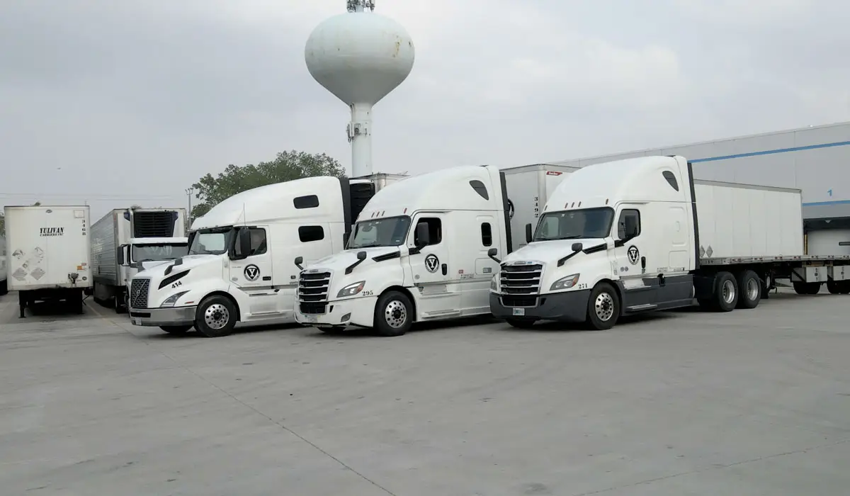Three white cargo trucks parked. | Green Logistics is 3PL's Pledge