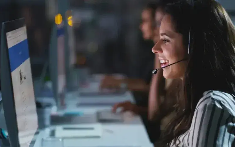 a-woman-wearing-a-headset-and-using-a-computer